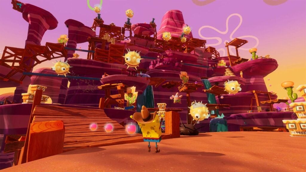 Feature image for our Spongebob Squarepants: The Cosmic Shake news piece. It shows Spongebob in a wild west level, wearing a cowboy hat, looking up at a large course of walkways.